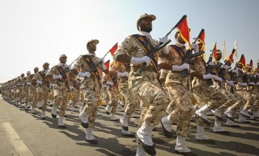 Members of Iranian revolutionary guard march during parade to commemorate anniversary of Iran-Iraq war, in Tehran